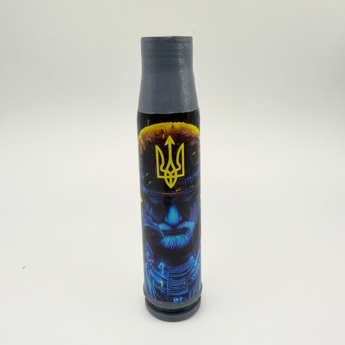 Decorated shell casing with a grey neck and base, featuring a blue moustached warrior wearing a tall dark hat with yellow trim and a yellow Ukrainian trident.