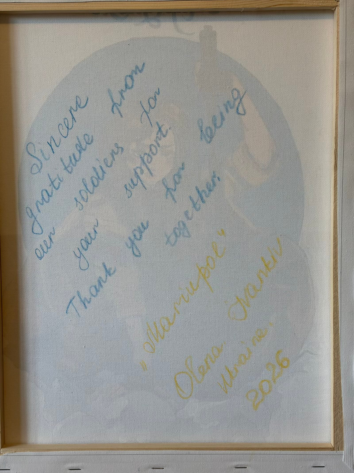 Reverse of the canvas with a wooden stretcher frame and handwritten dedication: “Sincere gratitude from our soldiers for your support. Thank you for being together.” Below are the title “Mariupol” and the signature Olena, Ivankiv, Ukraine, 2026.