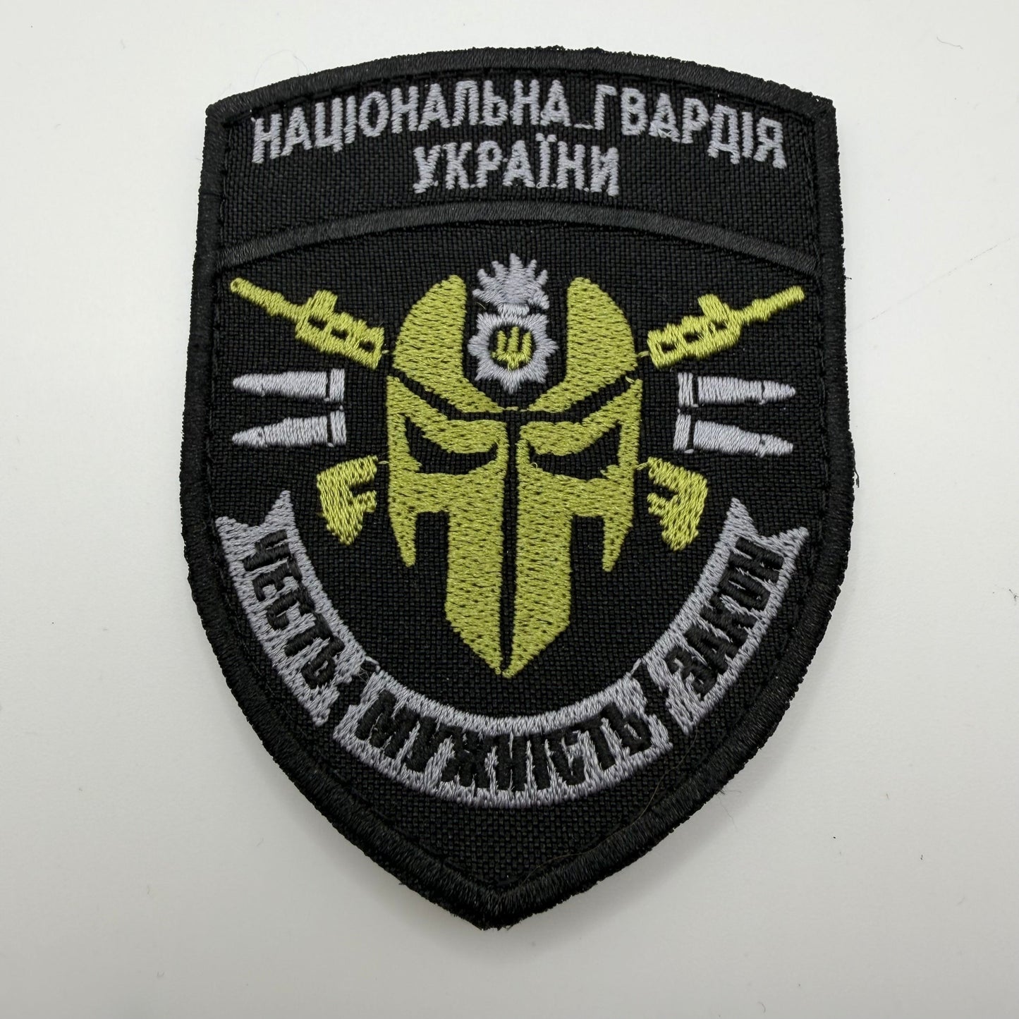 Embroidered patch with military design and text on a white background