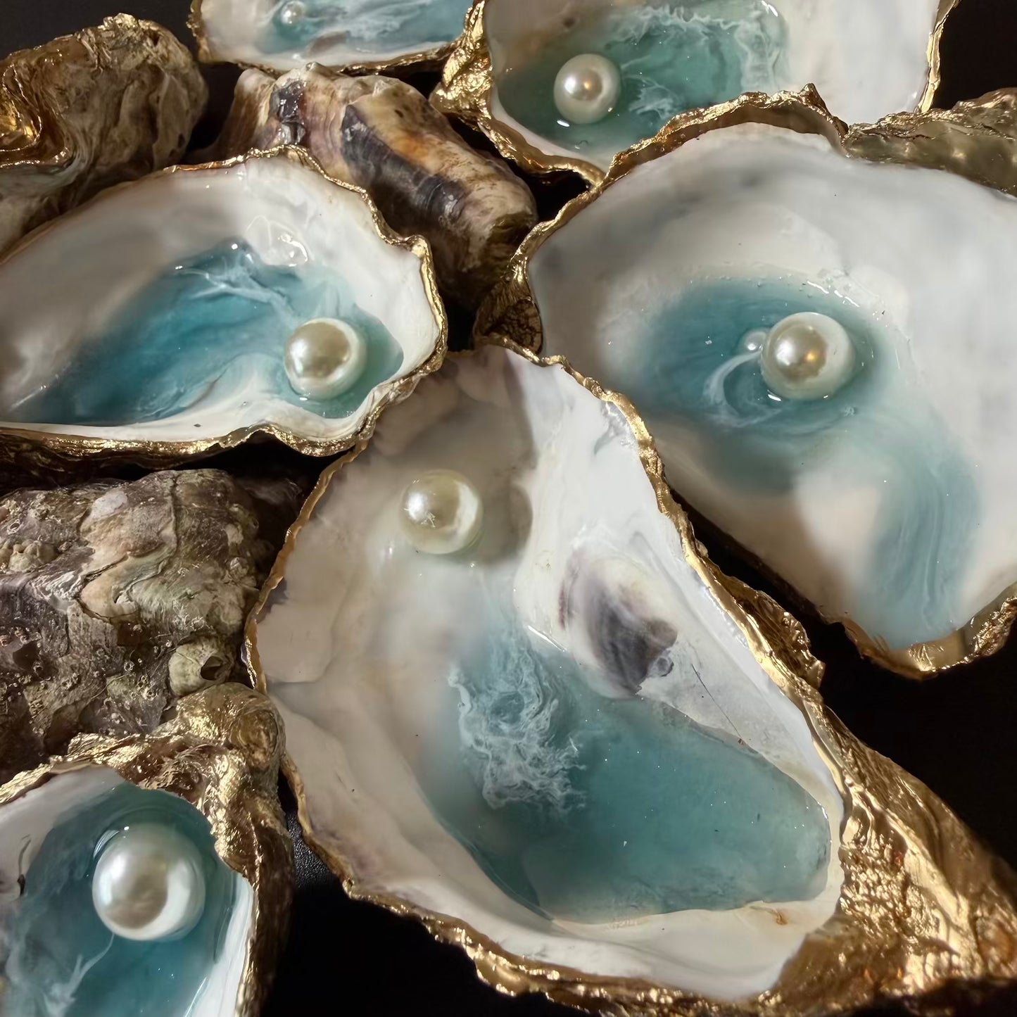 Oysters with pearls inside on a dark background