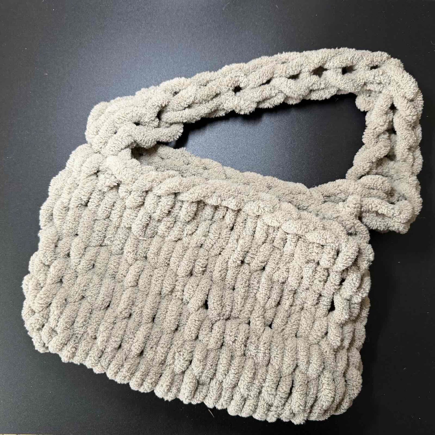 Gray knitted scarf on a black background