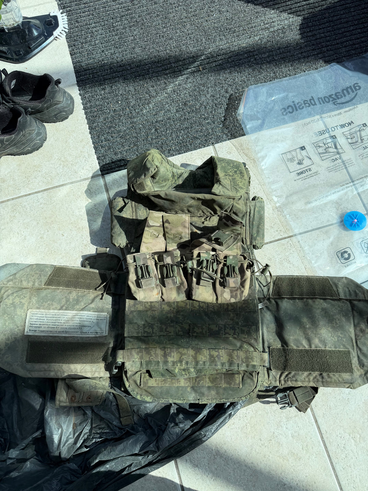 Captured Russian 6B45 body armour laid open, showing its EMR camouflage carrier, attached pouches and protective sections.