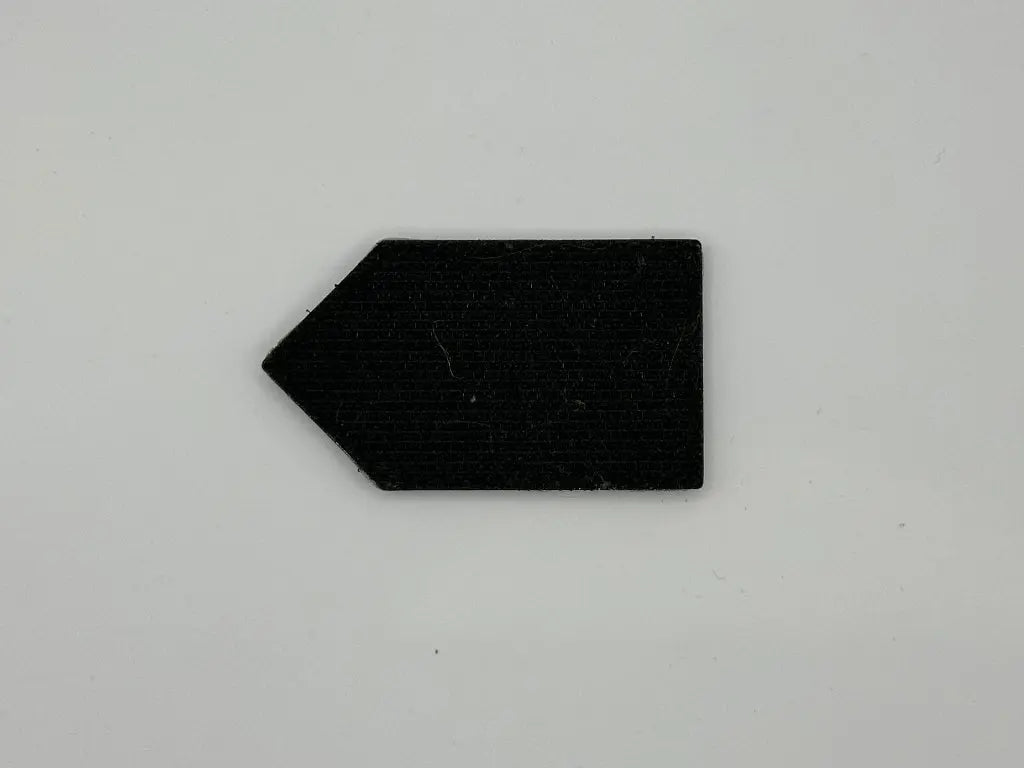 Black arrow-shaped object on a gray background