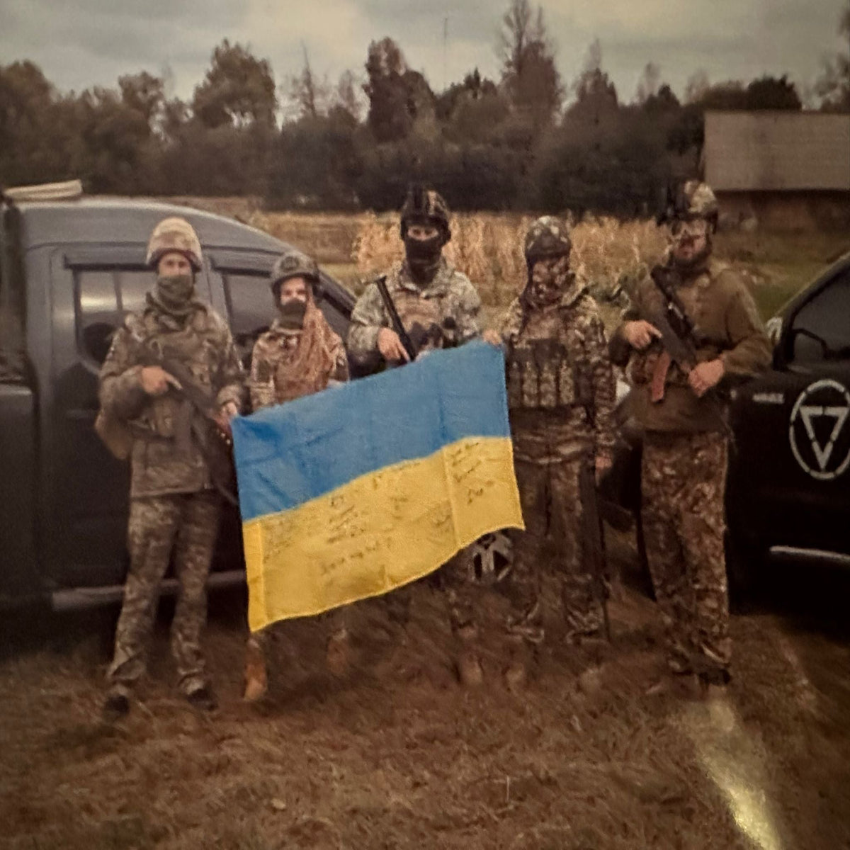 Provenance photo showing the flag being held by the soldiers who signed the flag