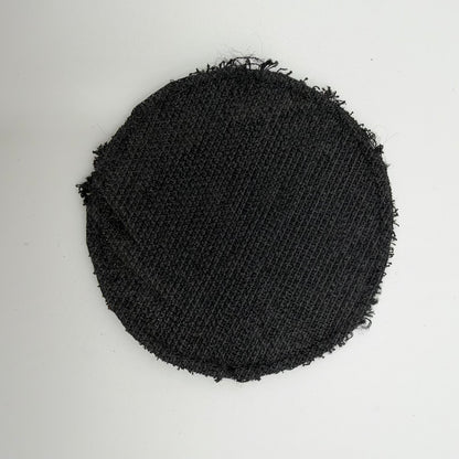 Reverse of the circular FREELANCER trophy patch, showing black textured backing and frayed edges.