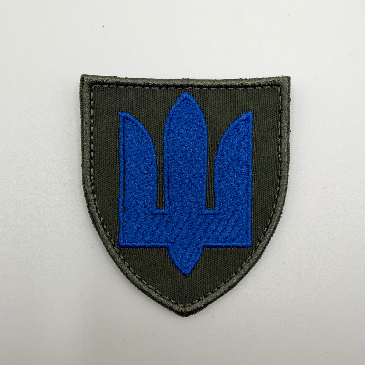 Ukrainian Mechanised Troops shield-shaped patch featuring a bright blue embroidered trident on olive-green fabric with an olive stitched border.