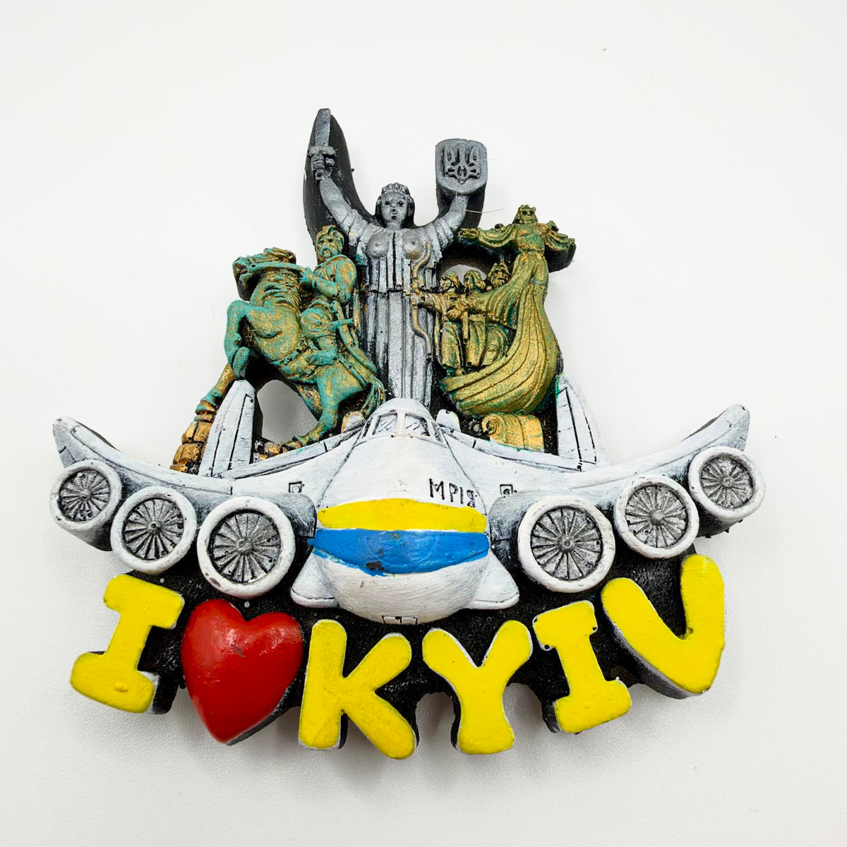 Sculpted “I love Kyiv” fridge magnet featuring the six-engine Mriya aircraft, Kyiv monuments, a sword-and-shield figure bearing a Ukrainian trident, and yellow lettering with a red heart.