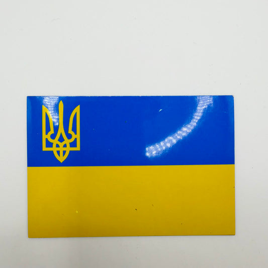 Rectangular Ukrainian flag fridge magnet with a blue upper half, yellow lower half and yellow Tryzub emblem in the upper-left corner.