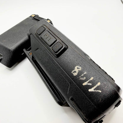 Side view of the TYT radio showing push-to-talk controls, worn handwritten markings and a detached battery.