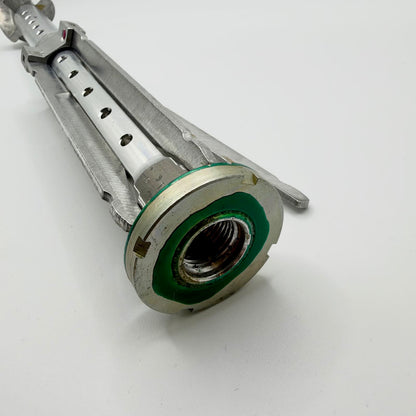 Close-up of the stabiliser’s circular threaded collar, green finish traces and folded fins alongside the perforated central tube.