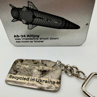 Marked metal keyring featuring a Kinzhal missile illustration and “Recycled in Ukraine” text, with a short chain and screw-closure fitting.