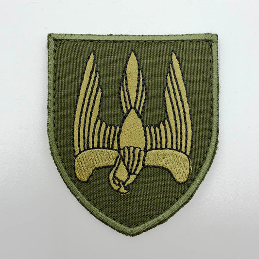 Olive-green shield-shaped embroidered patch featuring a khaki diving falcon outlined in black, with raised wings forming a trident-like silhouette.