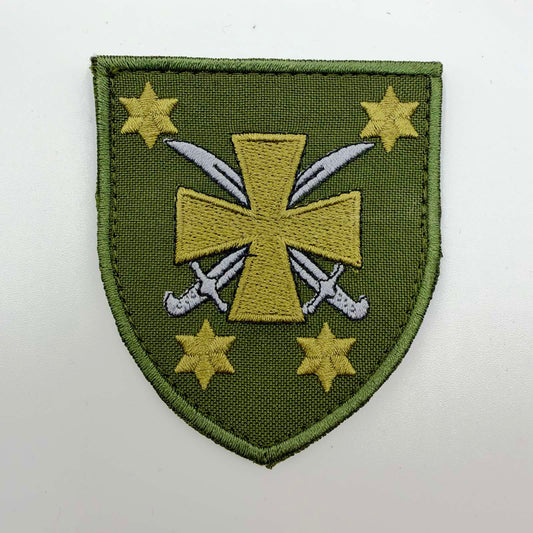 Olive-green shield-shaped embroidered 116th Separate Mechanised Brigade patch, featuring a gold-coloured Cossack cross over two silver-coloured sabres, surrounded by four six-pointed stars.