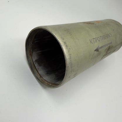 Angled view of the hollow metal cylinder showing its open end, recessed rim and Russian directional marking.