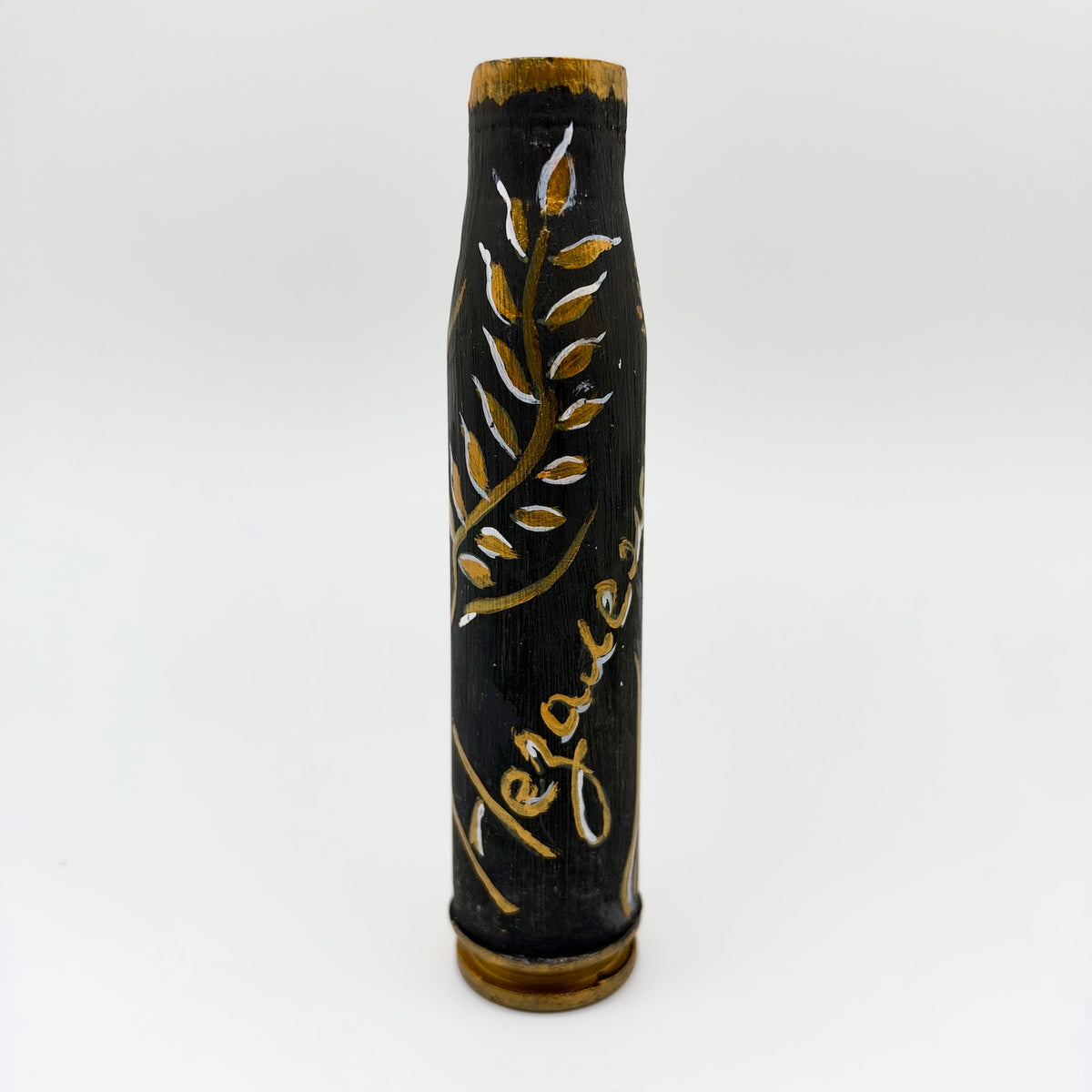 Upright shell casing hand-painted black with a curling gold leafy branch, white highlights, gold script, and gold accents around the rim and base.