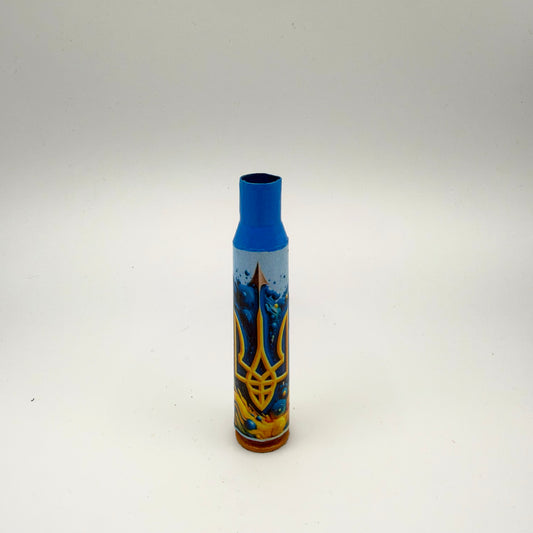 Slender decorated casing with a bright blue neck and golden-brown base, featuring a golden Ukrainian trident surrounded by swirling blue and yellow artwork.
