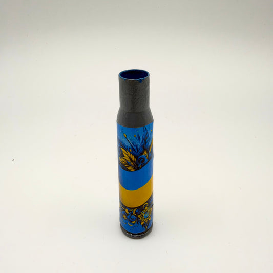 Decorated casing with a grey neck, featuring a curved blue and yellow Ukrainian flag band between ornate blue and gold leaves, floral patterns and swirling details.