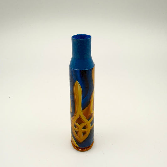 Decorated casing with a blue neck and golden-orange base, featuring a large golden Ukrainian trident with orange shading on a deep blue background.