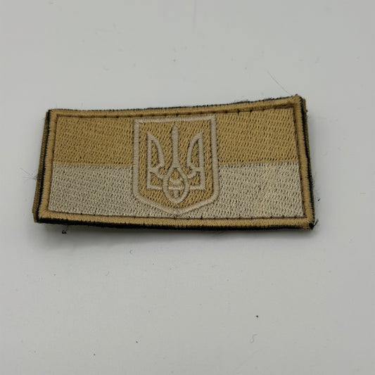 Tan velcro patch coloured to Ukraine flag with trident in the middle