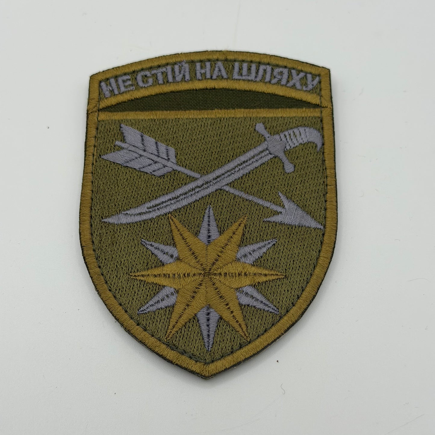 Military unit patch showing two crossed swords and a 9 pointed star