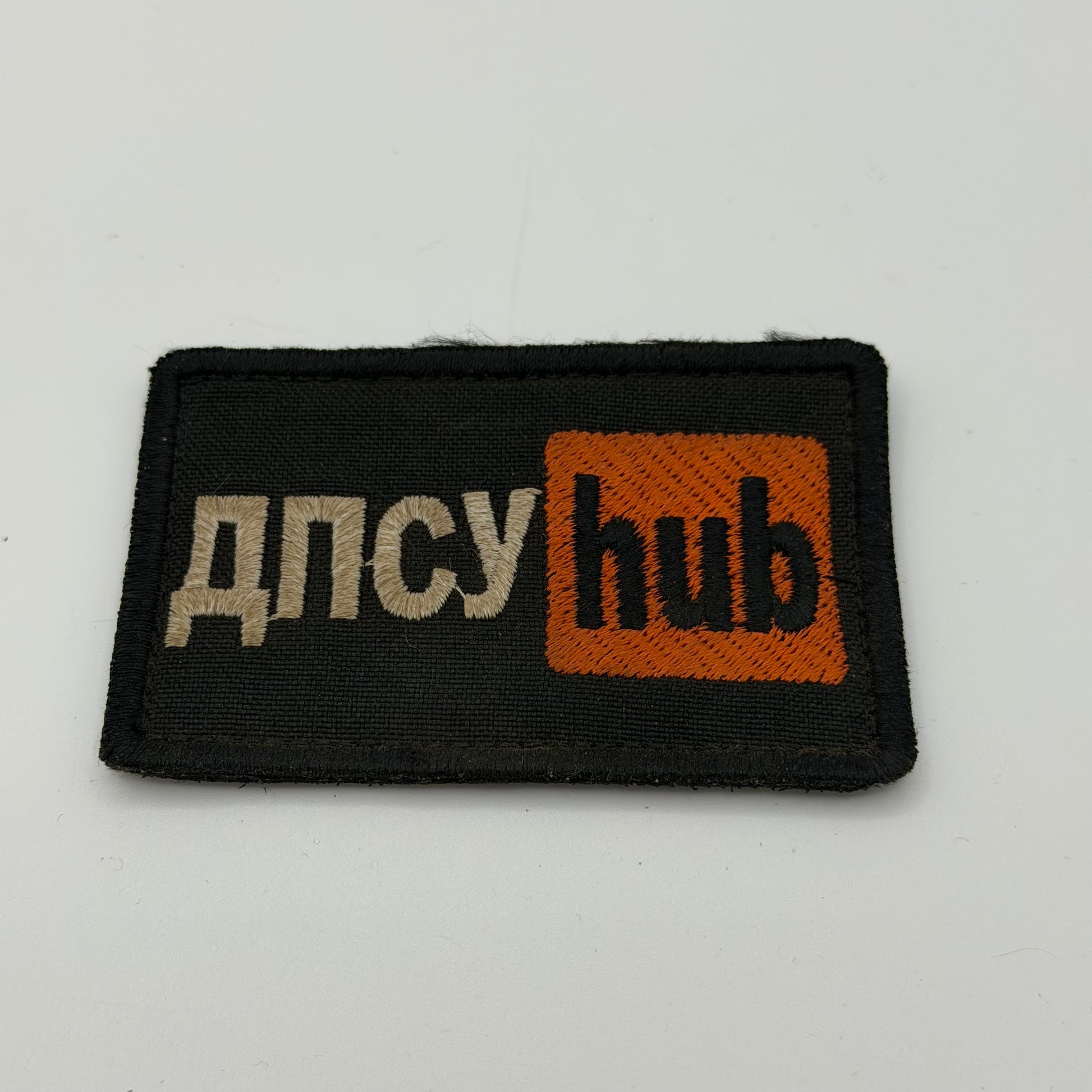 Black patch with the Words ДПСУ Hub written on them.