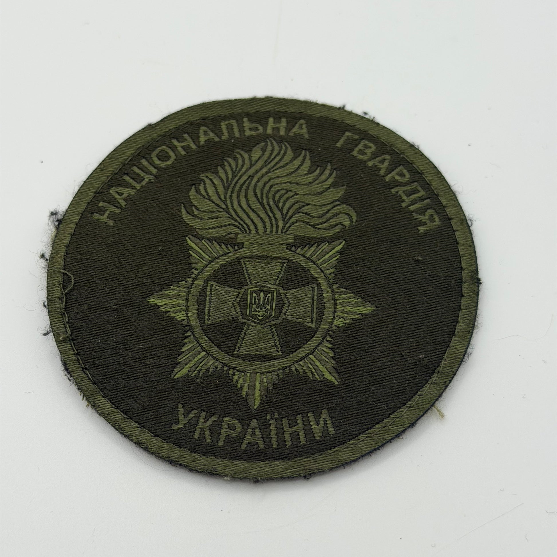 Velcro patch of the National Guard of Ukraine, depicting a Cross and star of Ukraine with a flaming torch