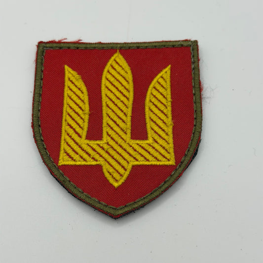 Red patch with gold Ukraine trident