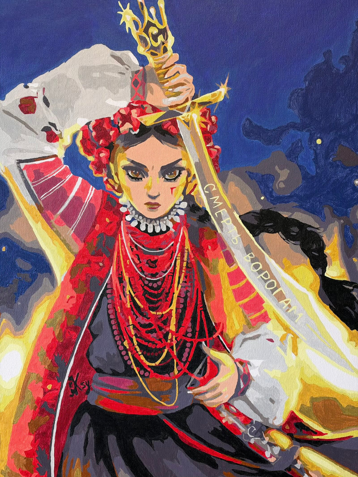 “Unbreakable”, a Ukrainian oil painting depicting a woman in an embroidered white blouse, red floral wreath and layered necklaces, raising a sword with a golden trident hilt. Her dark braid flows against a deep blue background surrounded by golden light. The blade reads “Death to the enemies” in Ukrainian.