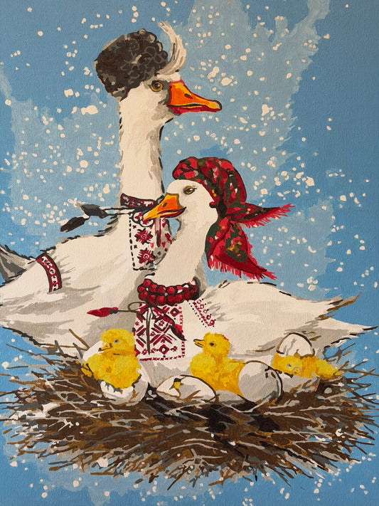 Oil painting of two white geese in Ukrainian folk-inspired clothing beside yellow goslings hatching in a twig nest. One goose wears a dark hat and embroidered shirt; the other wears a red floral headscarf, red beads and embroidery. A gosling peeks from beneath an eggshell against a pale blue, white-speckled background.