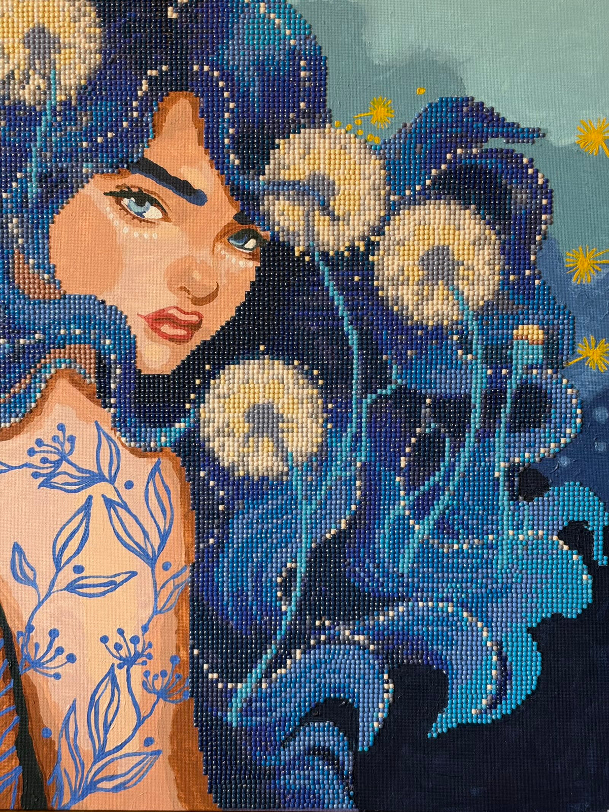 Mixed-media portrait combining oil painting and beadwork. A blue-eyed woman looks over her shoulder, with long blue and turquoise hair decorated with pale beaded butterflies. Blue botanical patterns cover her shoulder and back, while yellow starbursts dot the background.