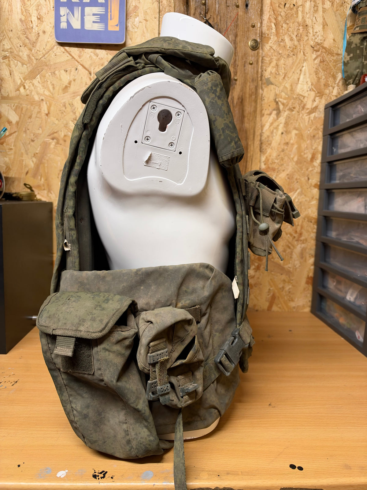 Side view of the captured Russian 6B45 body armour displayed on a mannequin with its collar and pouches attached.