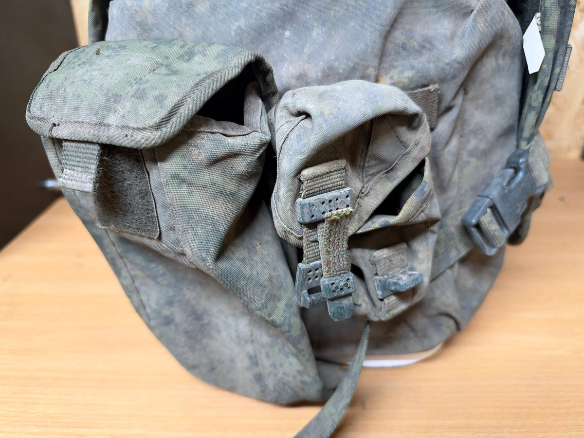 Close-up of the dusty and worn utility pouches attached to the side of the captured Russian body armour.