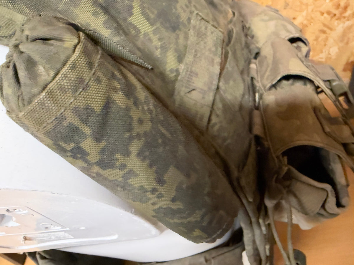 Close-up of the vest’s detachable shoulder and upper-arm protective sections in dirty EMR camouflage.