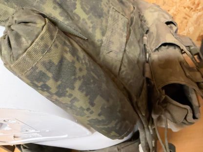 Close-up of the vest’s detachable shoulder and upper-arm protective sections in dirty EMR camouflage.