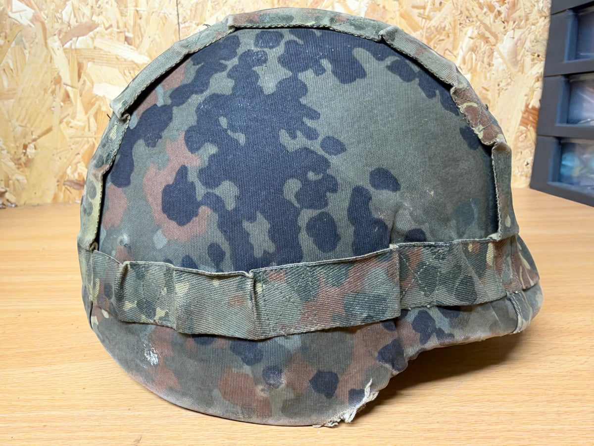 Right-side view of the probable Spanish MARTE III helmet in its faded Flecktarn cover, formerly used by a Ukrainian soldier.