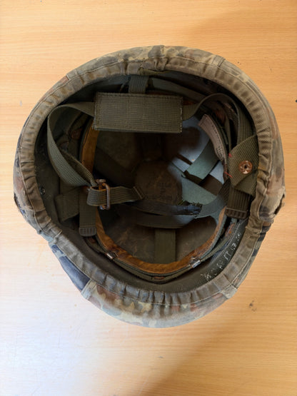 Overhead view inside the Spanish MARTE helmet, showing its suspension harness, chin straps, liner and aged leather components.