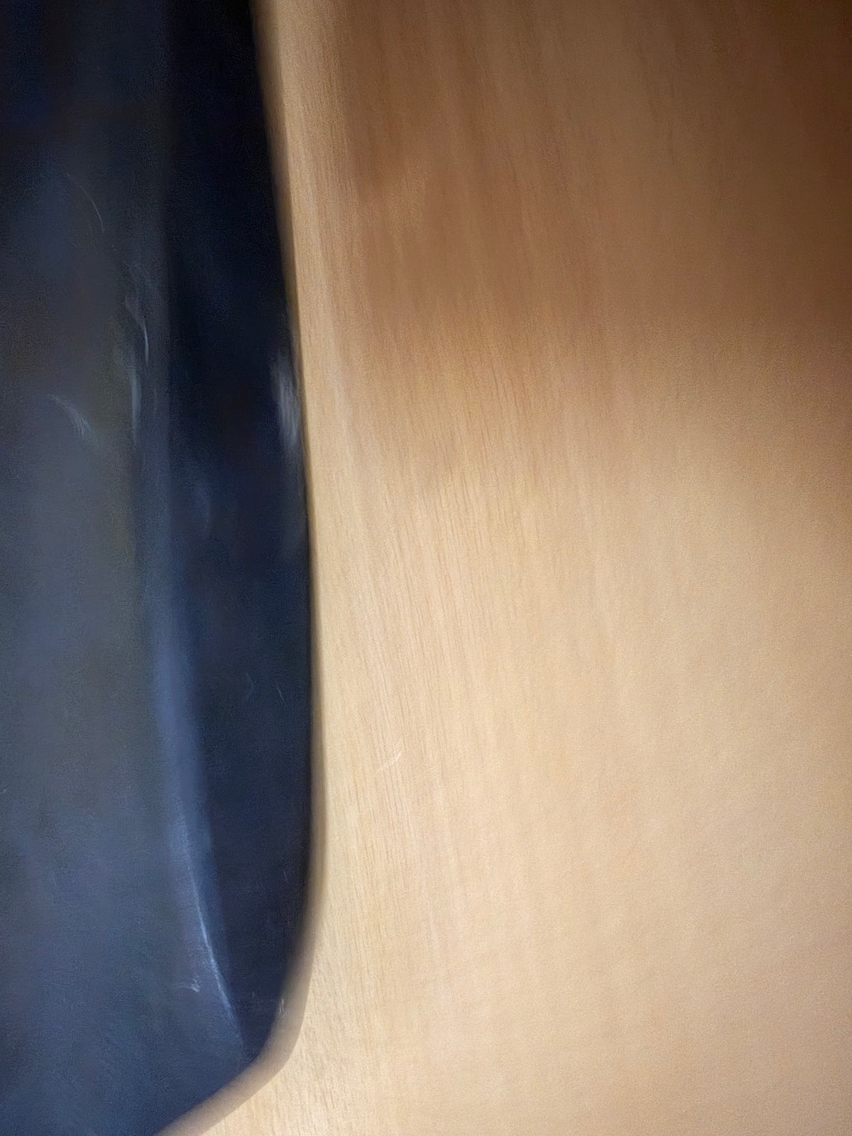 Edge-on view of the Geran-2 stabiliser showing the thickness and curved profile of the surviving black composite panel.