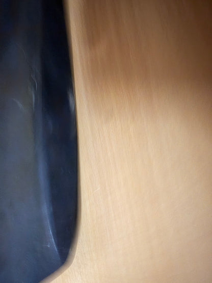 Edge-on view of the Geran-2 stabiliser showing the thickness and curved profile of the surviving black composite panel.