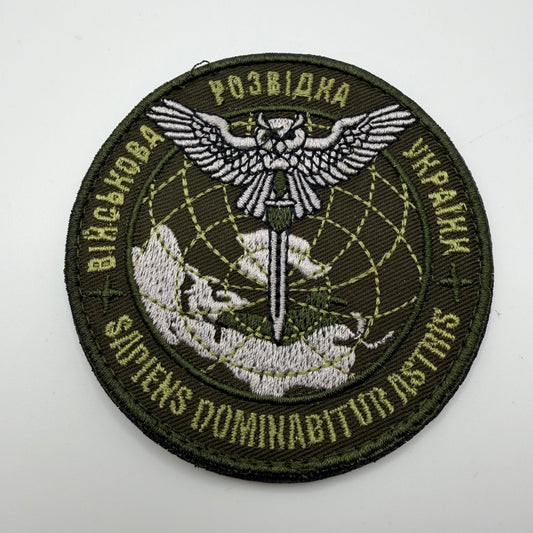 Circular patch with embroidered design on a white background