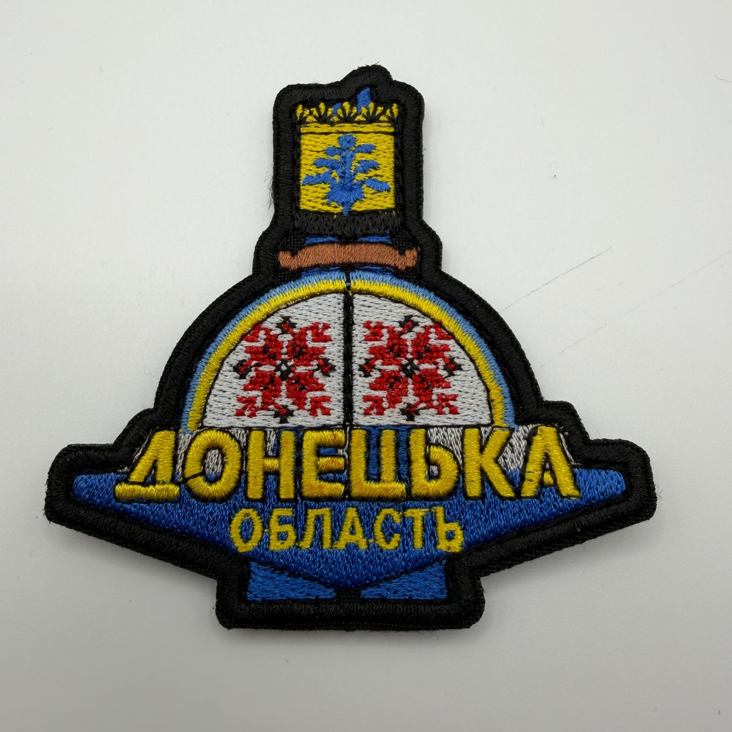 Emblem with decorative elements and text on a white background