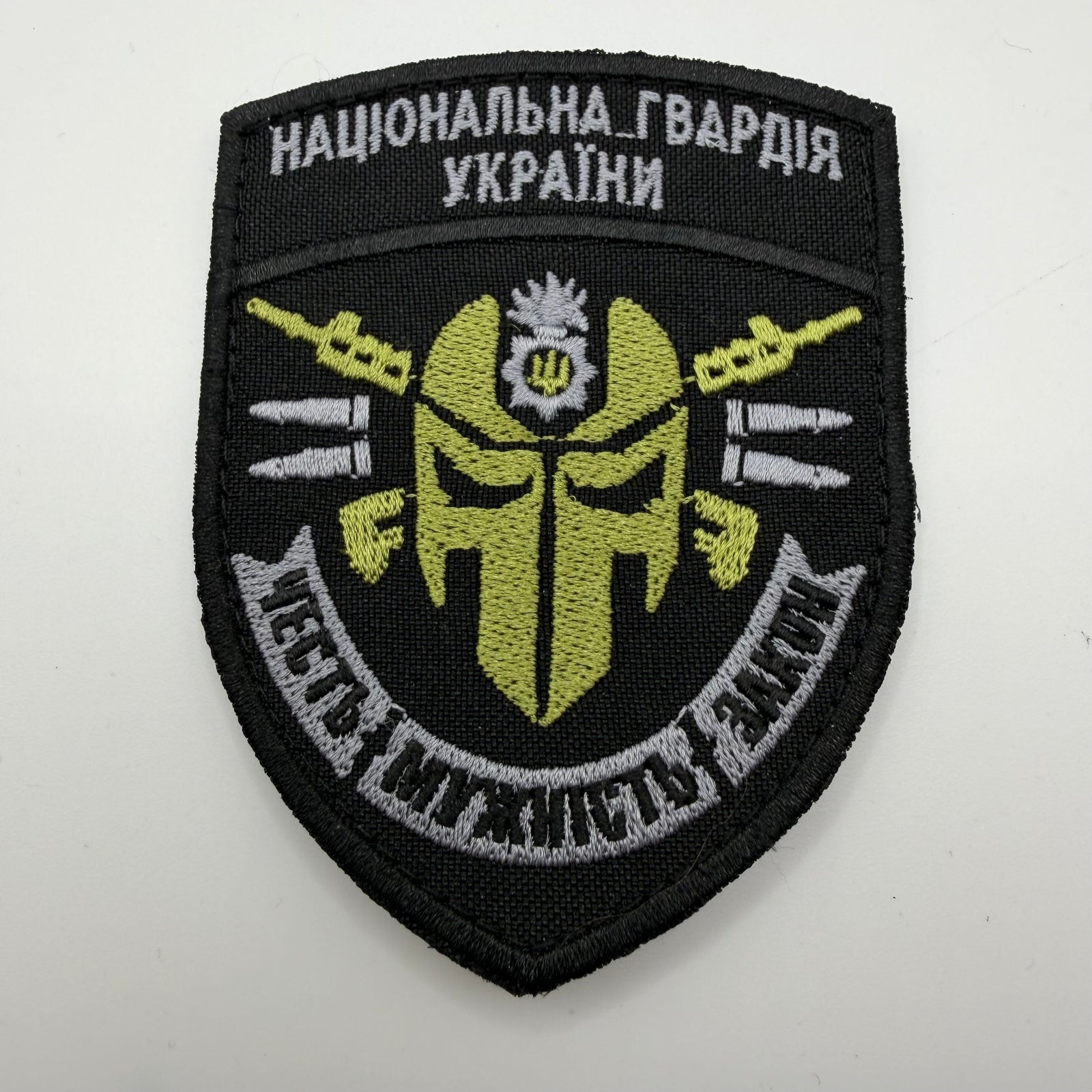 Embroidered patch with military design and text on a white background