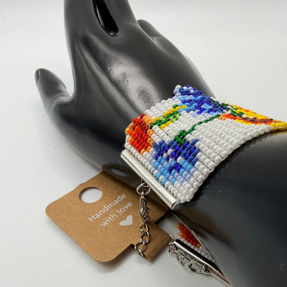 Colorful beaded bracelet on a black mannequin hand with a 'Handmade with Love' tag.