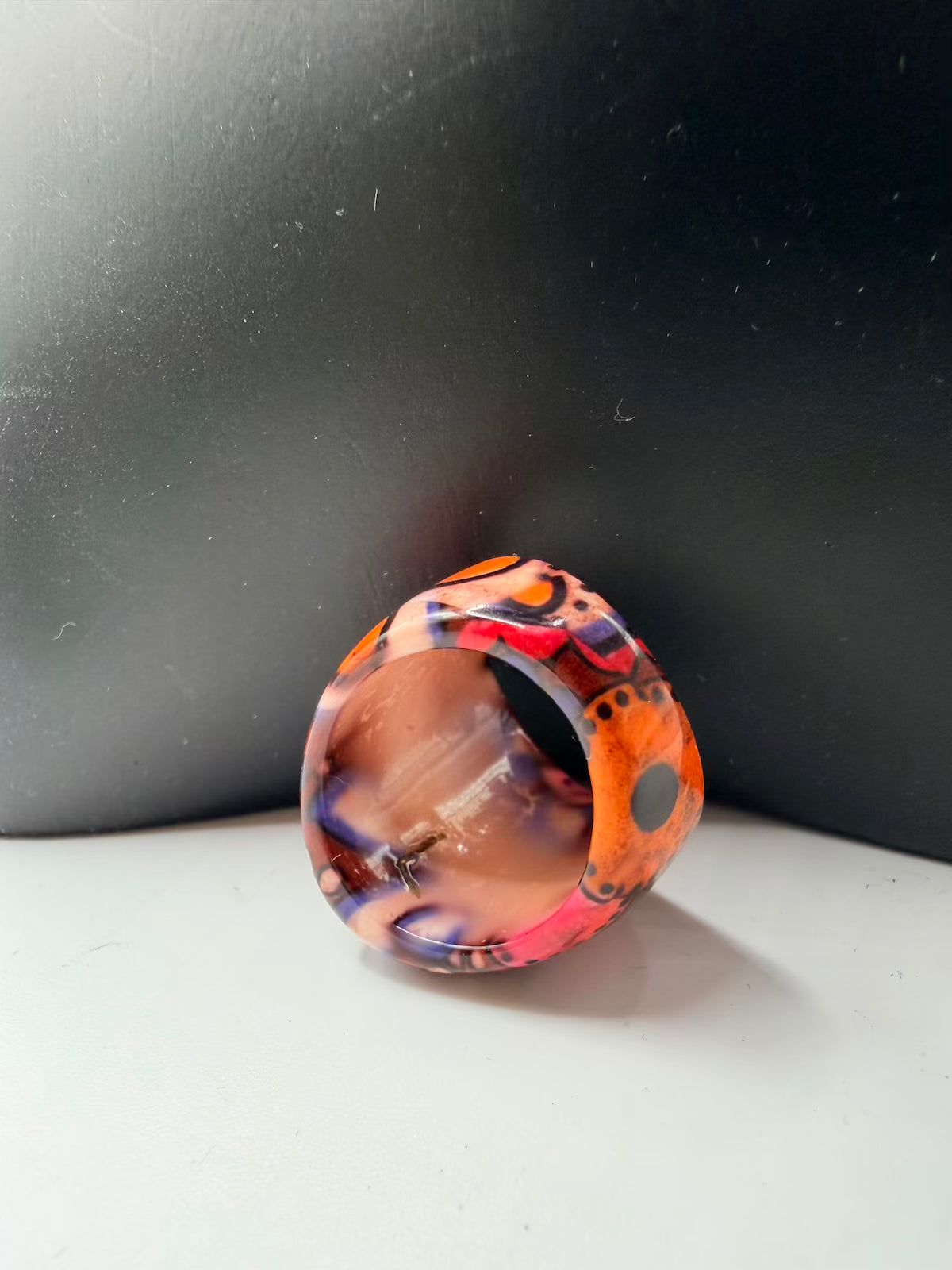 Multicolored ring on a reflective surface with a dark background