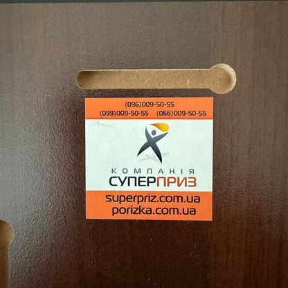 Cardboard box with a label featuring text and a logo on a brown background