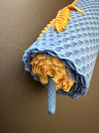 Close-up of a rolled-up blue and yellow towel on a brown surface