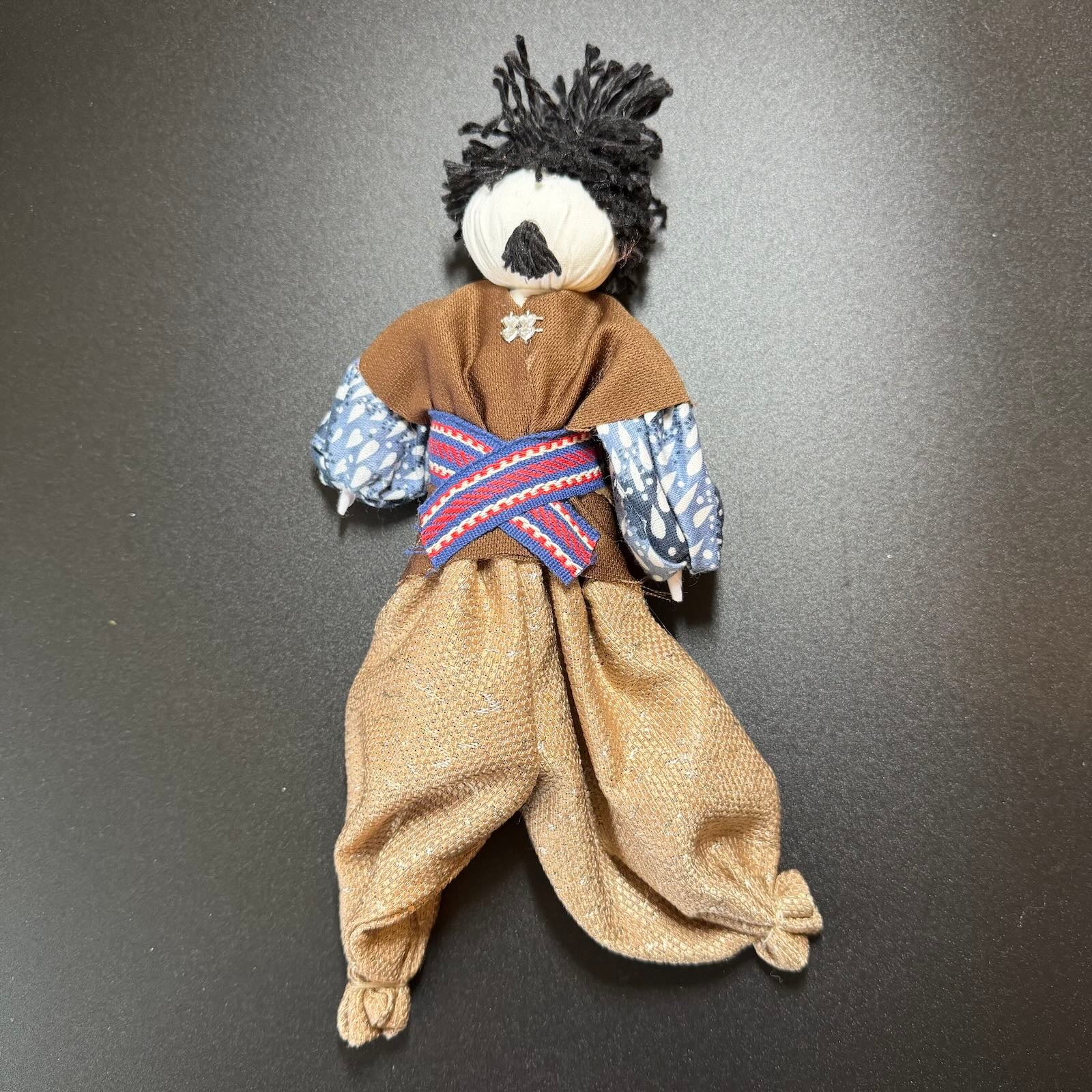 Traditional dolls with clothing on a dark background