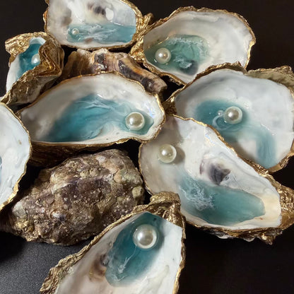 Open oysters with pearls inside on a dark background