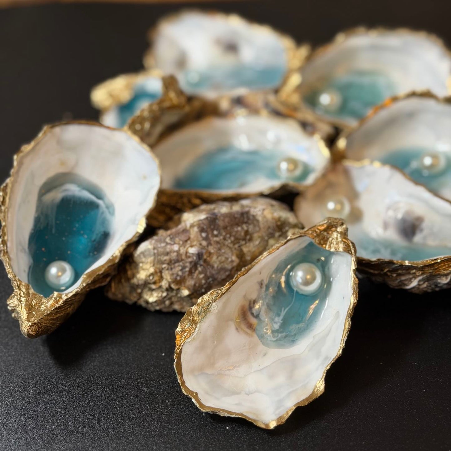 Decorative oyster shells with pearls on a black background