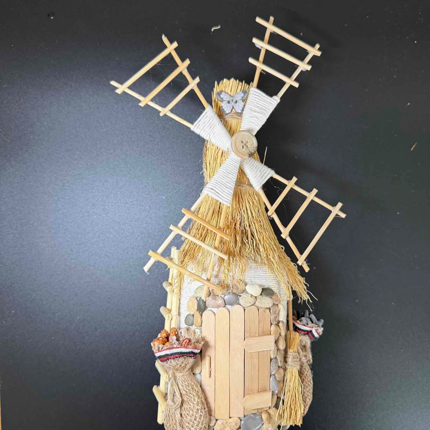 Decorative windmill sculpture on a dark background
