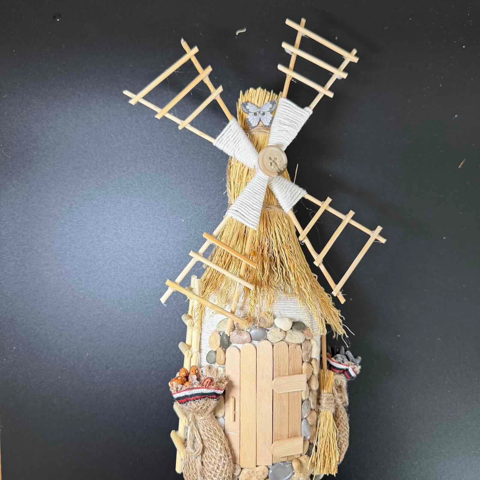 Decorative windmill sculpture on a dark background